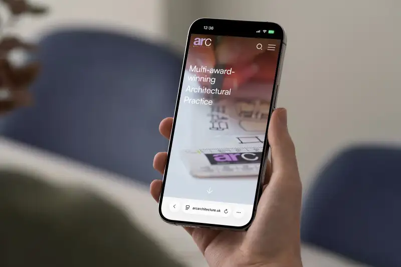mockuuups iphone 15 pro mockup in hand against blurred background