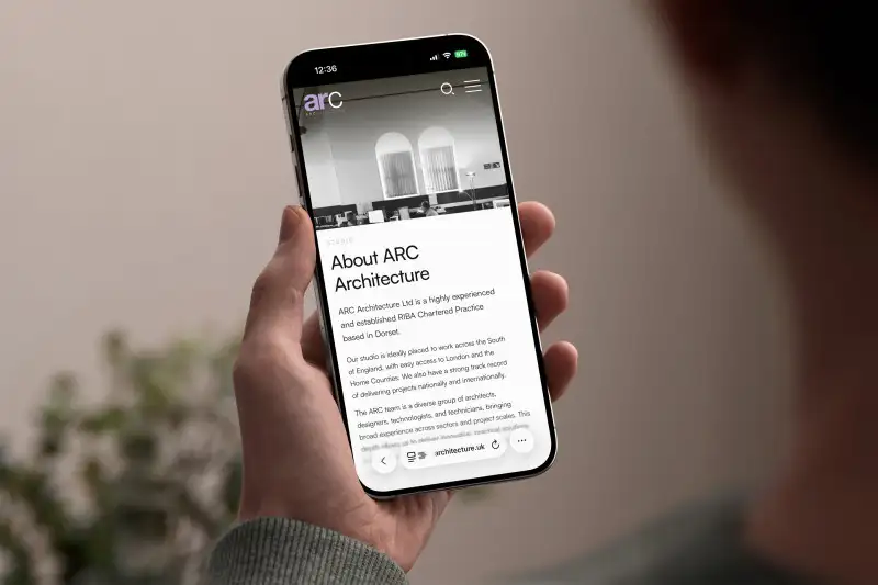mockuuups iphone 15 pro mockup in male hand against neutral background