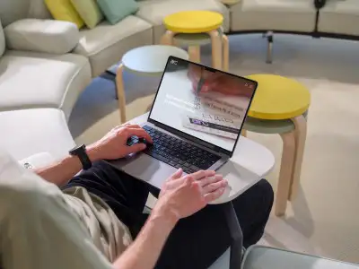 mockuuups macbook pro mockup with a man in a casual workspace