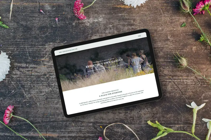mockuuups top view of landscape tablet mockup next to flowers