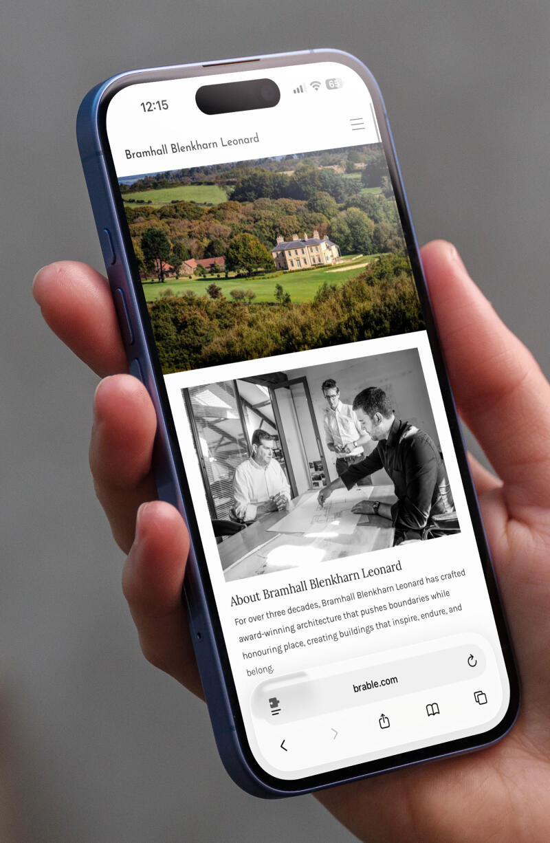 mockuuups iphone 16 mockup in a womans hand with concrete backdrop