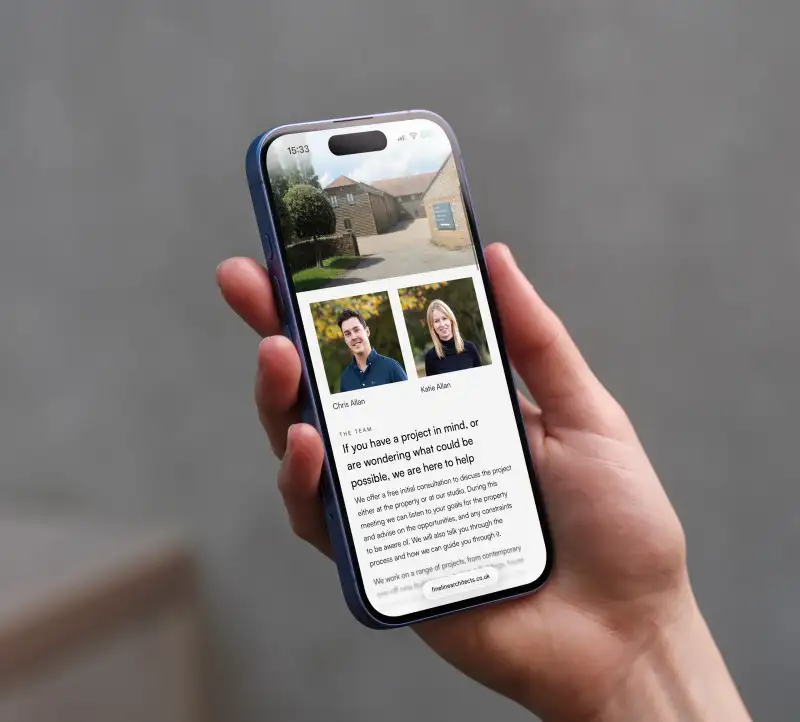 mockuuups iphone 16 mockup in a womans hand with concrete backdrop