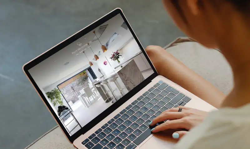 mockuuups woman working on a macbook air mockup