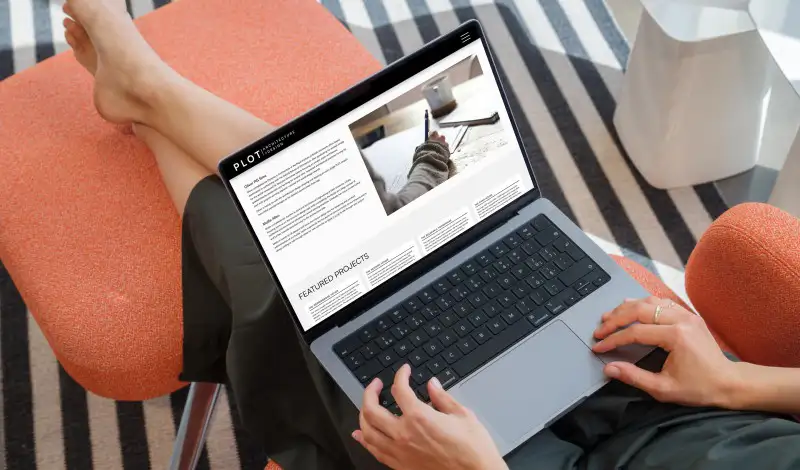 mockuuups macbook pro mockup with a woman relaxing on a chair