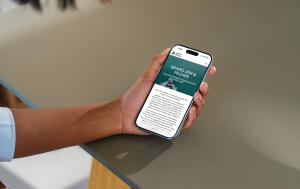 mockuuups iphone 15 pro mockup in a womans hand at a modern desk