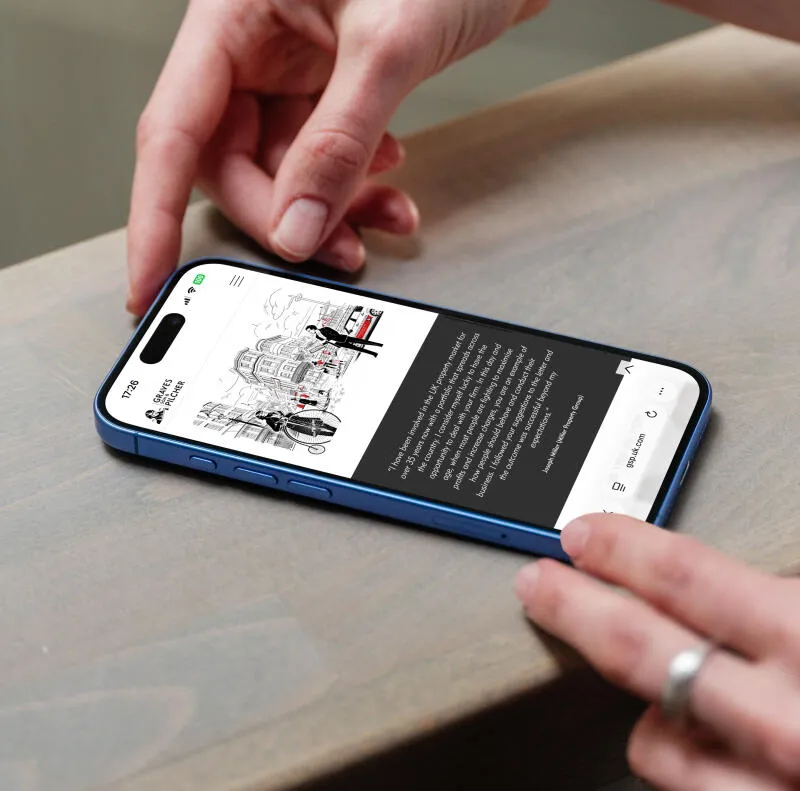 mockuuups iphone 16 mockup on a wooden surface with a hand interacting