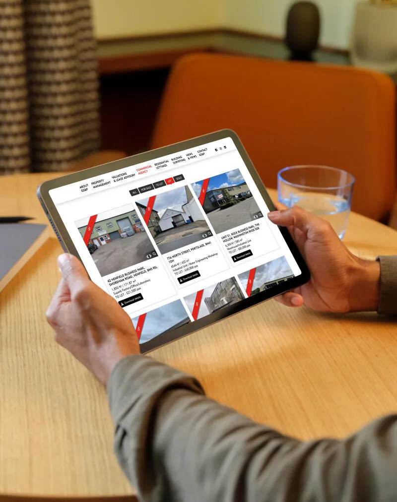 mockuuups man holding a ipad mockup in the lounge