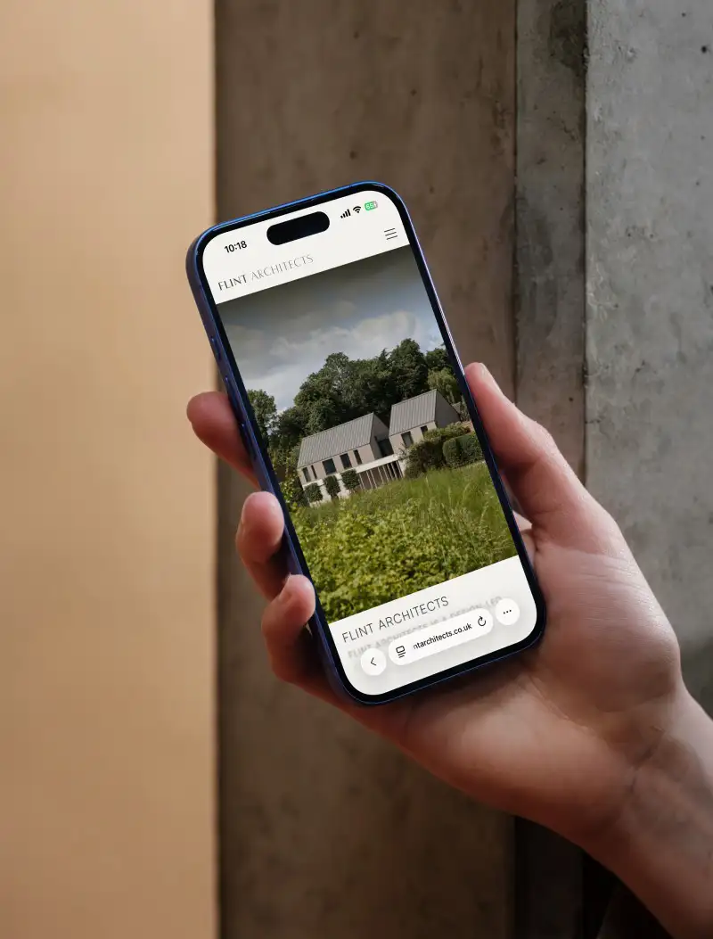 mockuuups iphone 16 mockup held against a concrete wall