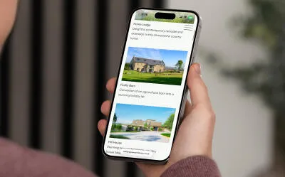 mockuuups iphone 15 pro mockup in a mans hand against an indoor background