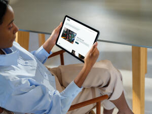 mockuuups ipad air mockup in a womans hand at a modern office