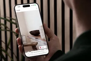 mockuuups iphone 15 pro mockup in a male hand against a modern backdrop