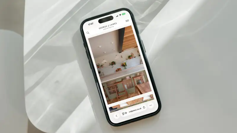 mockuuups iphone 15 pro mockup on a white modern table