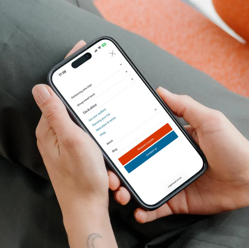 mockuuups iphone 15 pro mockup in a womans hand on a cozy couch